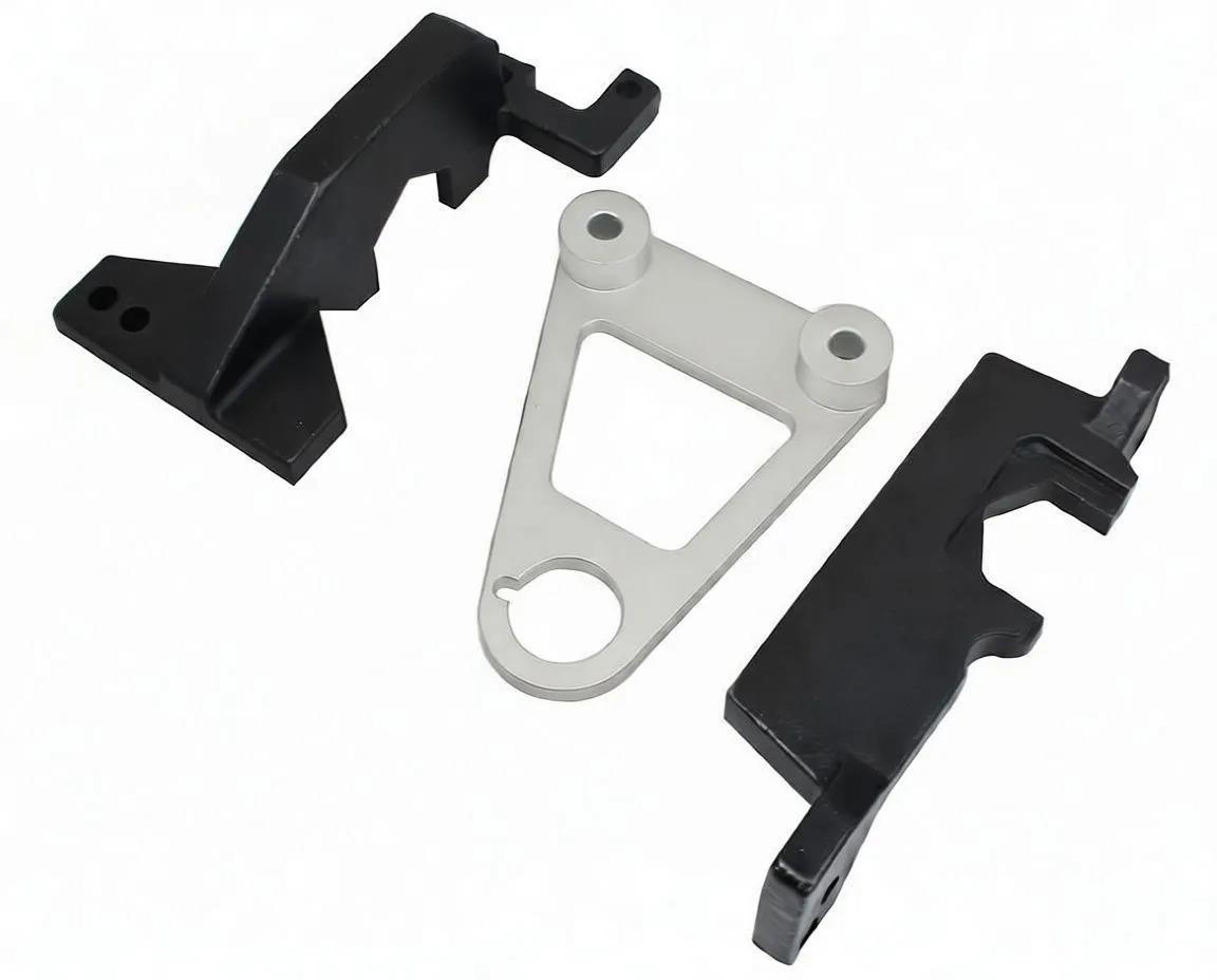 Three timing kit components laid out: black angled bracket, silver triangular cam plate with two bosses, and black multi-notch locking plate with 'satra' marking