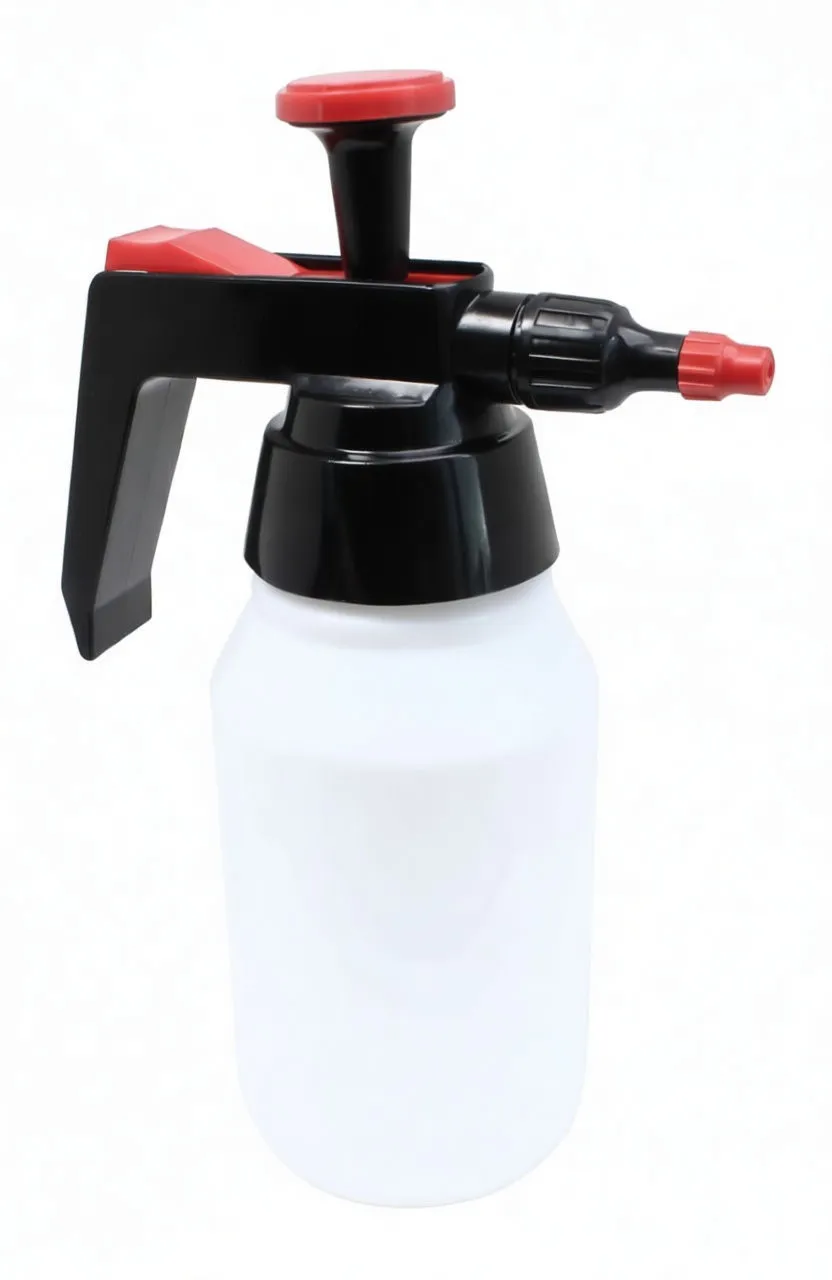 Angled left portrait of sprayer showing black handle, red pump top and red-tipped adjustable nozzle, 'saTra' logo on bottle