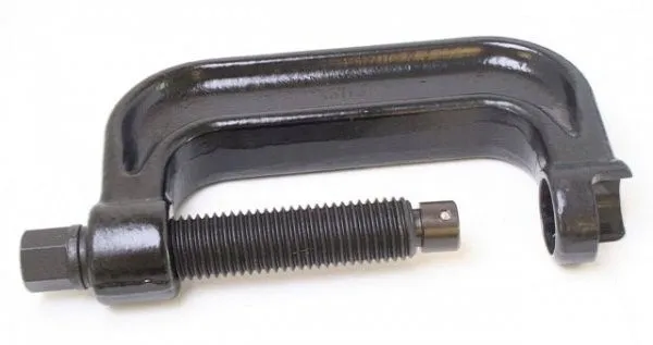 Close-up of black C-frame press with threaded spindle and hex drive