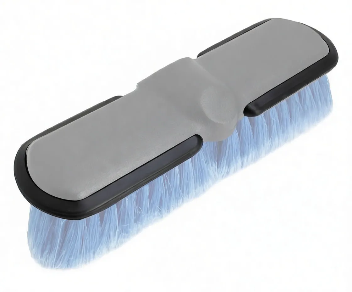 Underside of brush head showing black rubber protective bumper with label 'Miękka Gumowa Osłona' and blue bristles