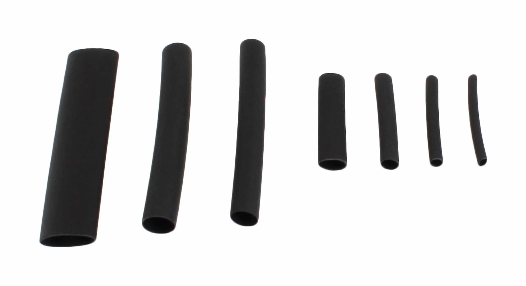 Row of individual black heat shrink tubes of varying sizes on white background