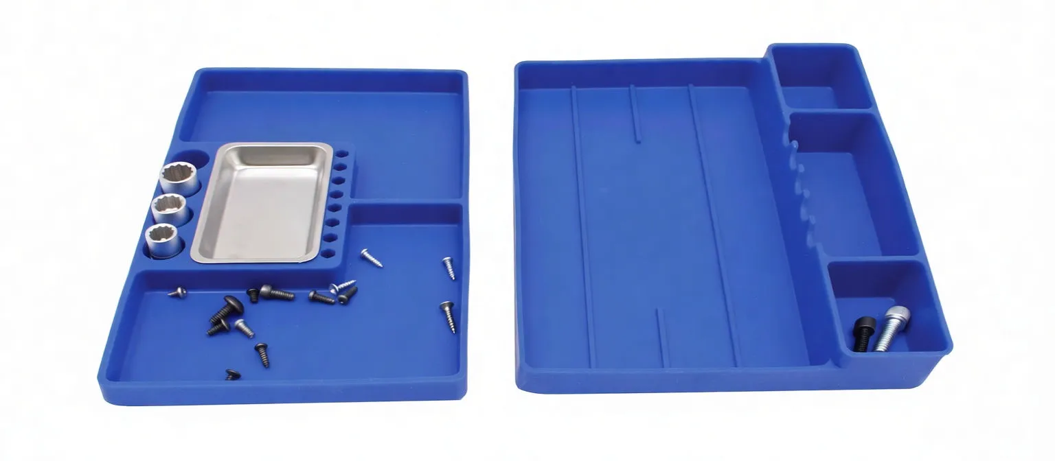 Two blue trays flat with screws and sockets placed in compartments and a small stainless steel parts tray in one recess.