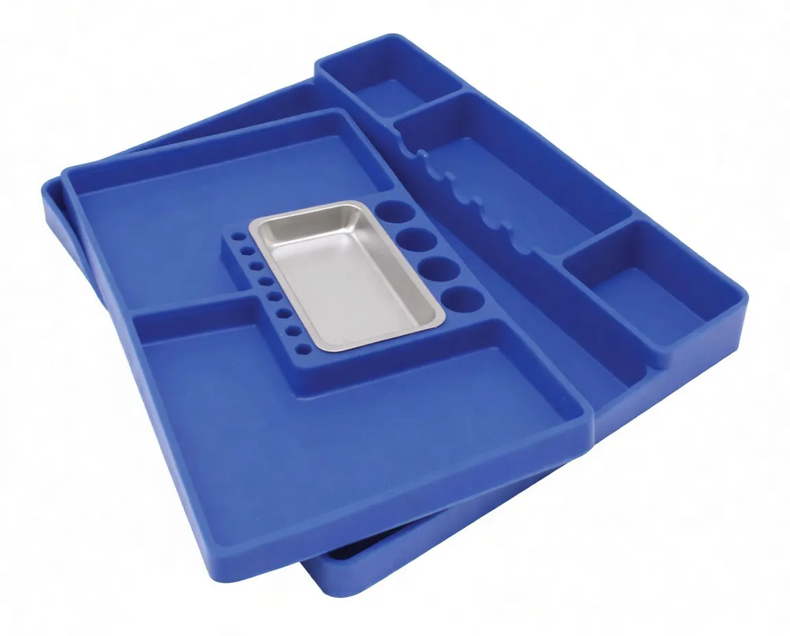 Stacked blue silicone tool trays showing compartments, finger-groove slots and a stainless steel insert in the central recess.