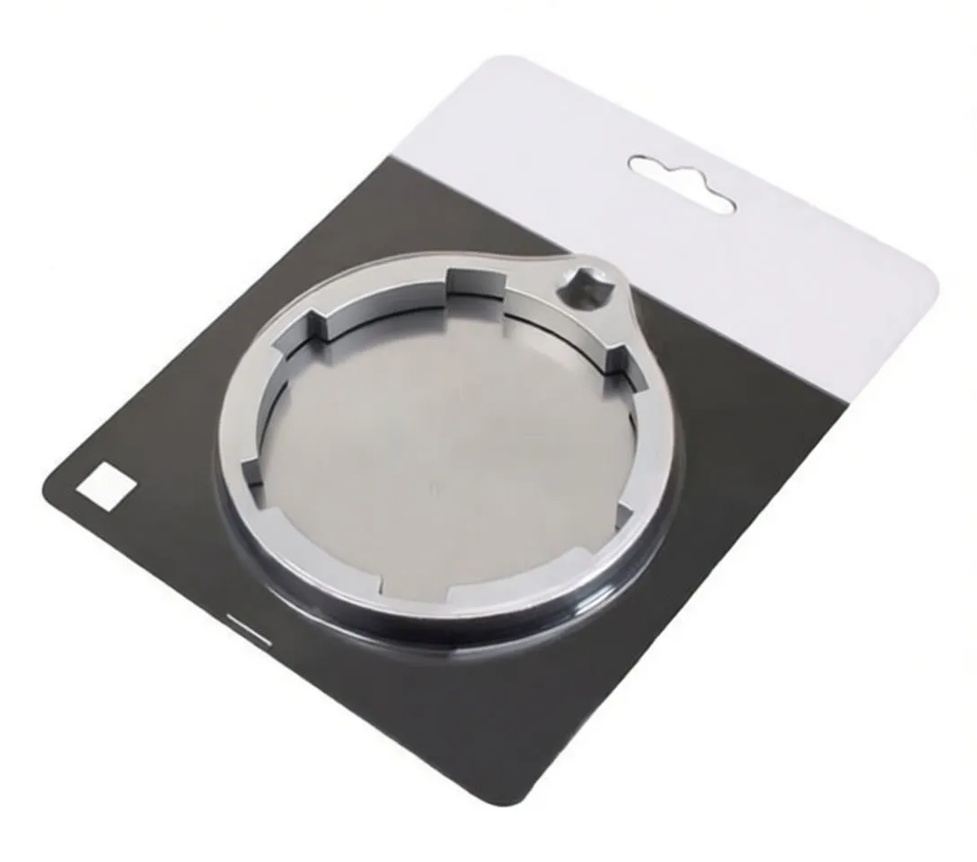 Angled view of silver ring filter wrench showing inner engagement tabs, thickness and engraved brand/part marking