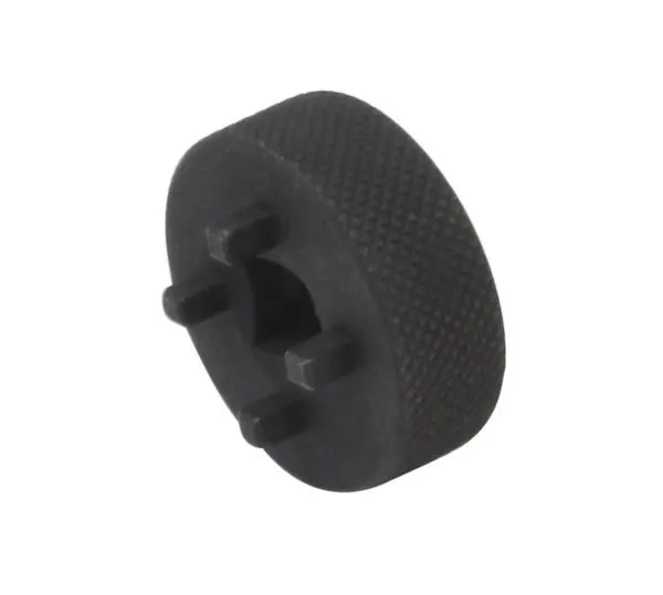 Side/angled view of black pump key showing four engagement tabs around a central square 3/8" drive recess and knurled edge.