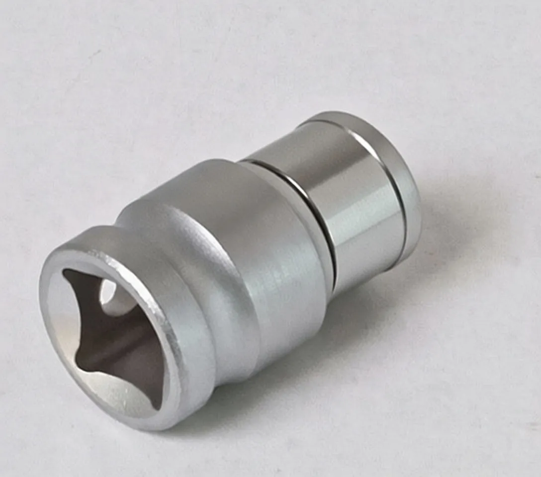 Angled image of silver socket adapter showing six-point 8mm socket, chrome collar with detent ball, embossed mark and stepped rings on the body.