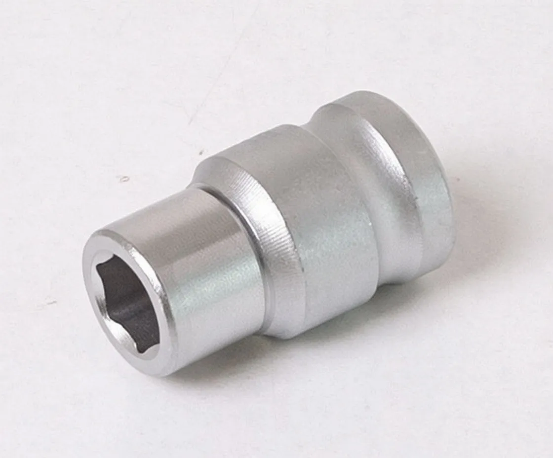 Perspective of adapter showing polished drive collar with detent ball and spring clip, barrel hole for pin, and partially visible 6-point socket end.