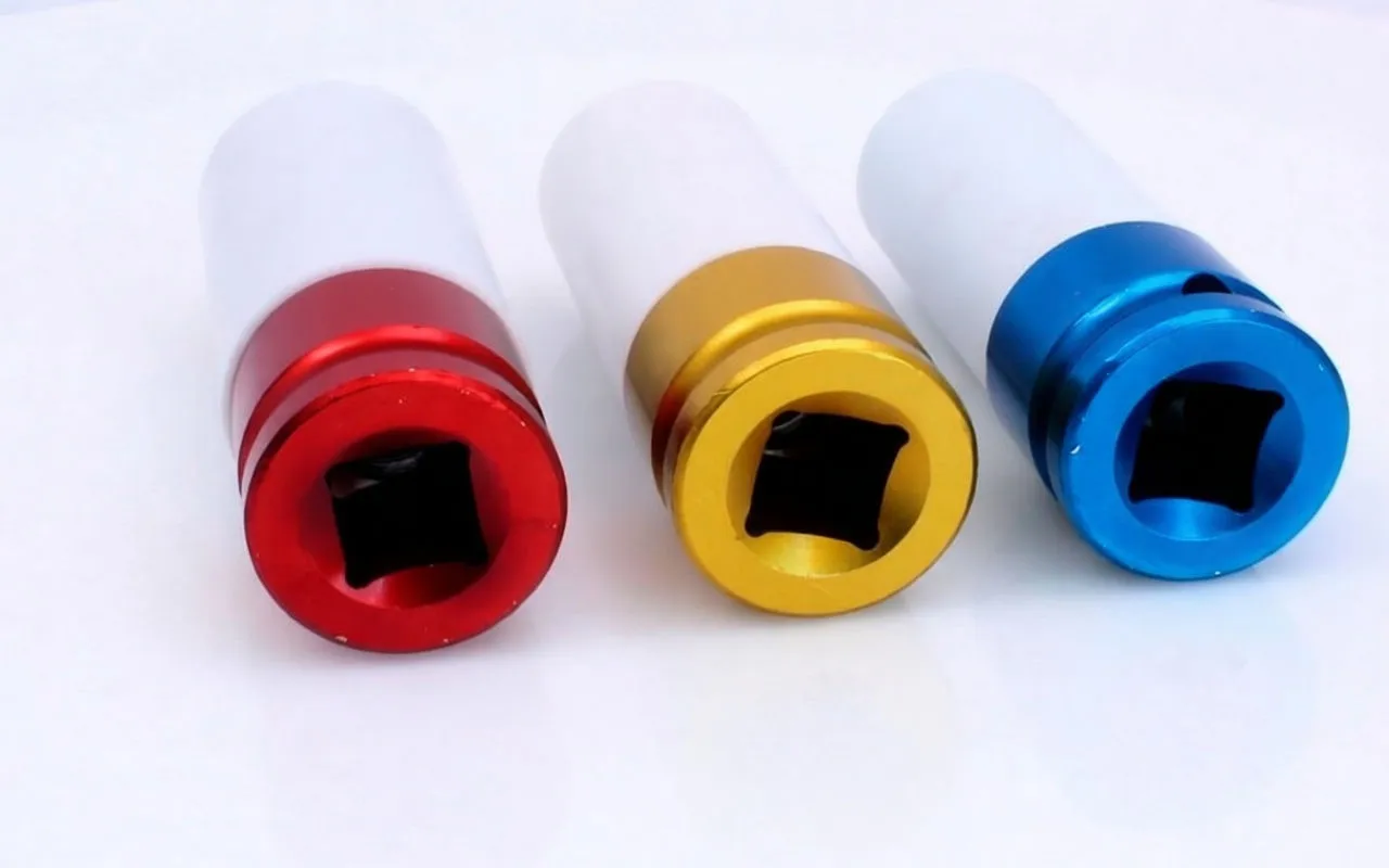 Front view of three impact sockets showing square drive openings in red, gold and blue collars with white sleeves.