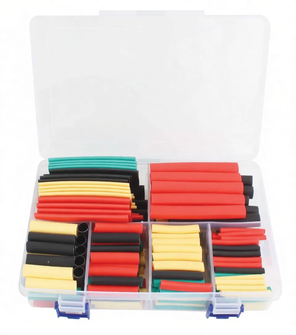 Top-down view of a clear storage box with organized multicolored heat shrink tubing and a faint paper insert visible under the lid