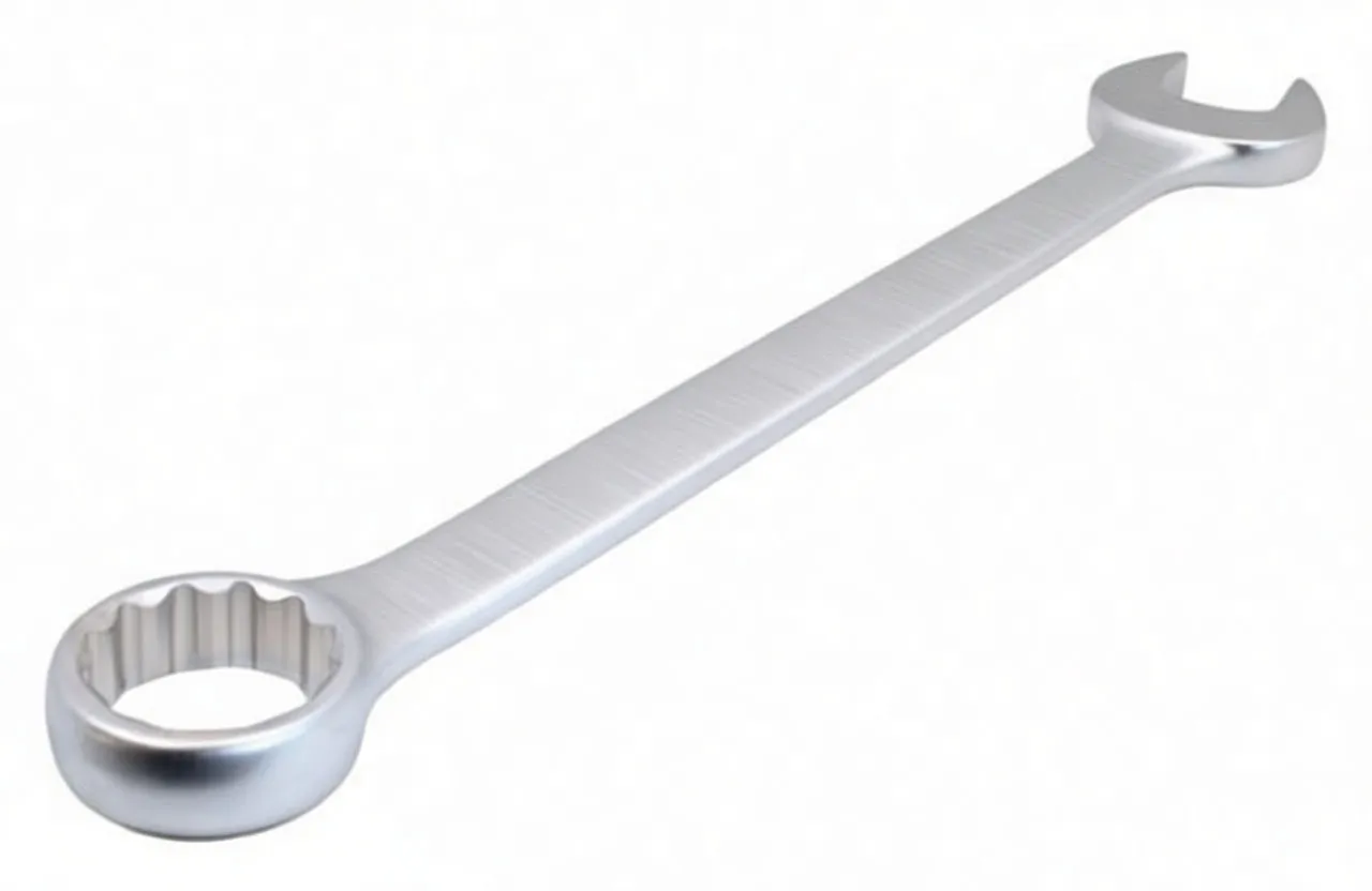 Angled perspective of matte silver combination wrench with 12‑point box end close to camera and open jaw at the far end, embossed logo on handle.