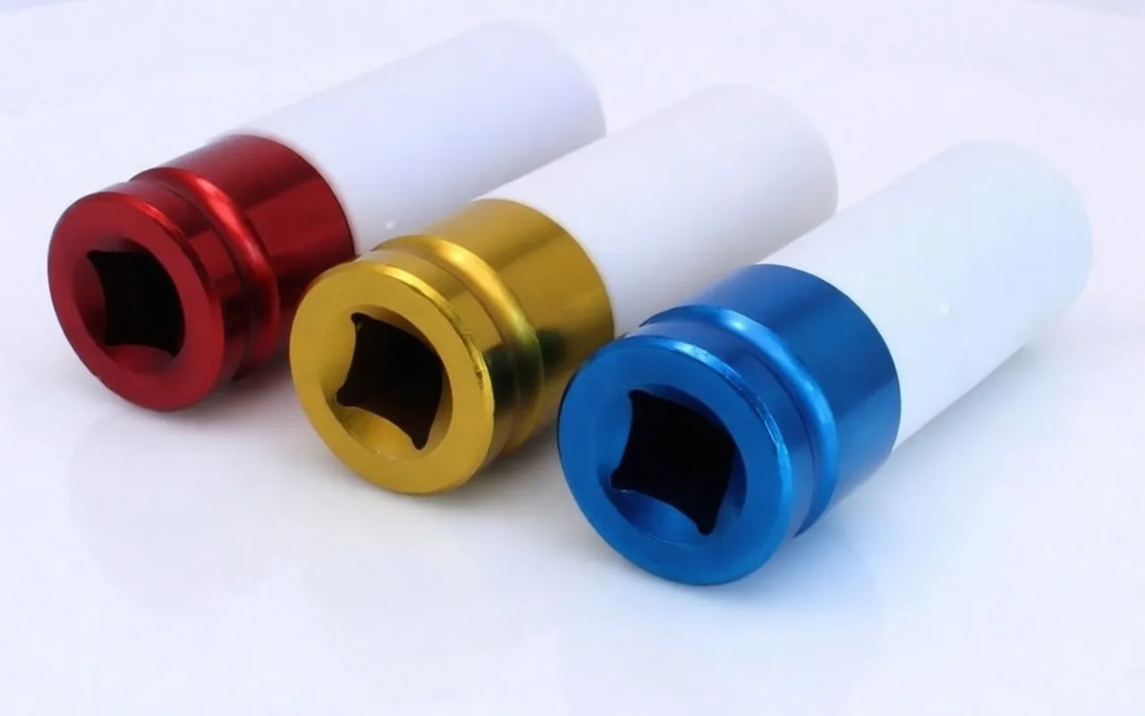 Three impact sockets on white background showing square drive ends, retention holes and printed markings on colored collars.