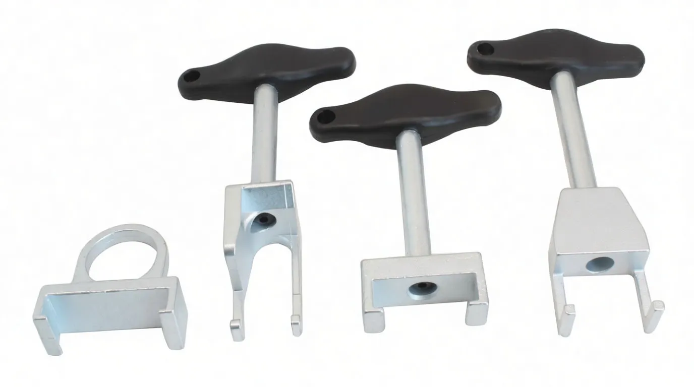Four spark plug puller tools laid out: one ring adapter and three T-handle pullers with different fork ends, showing a stamped marking on one head.
