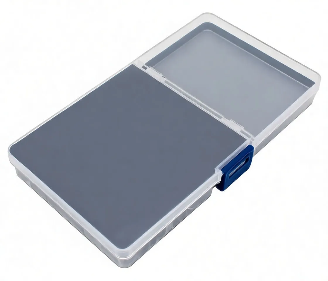 Angled open organizer showing compartments of colored grommet rings and a knurled punch tool with die, lid chart showing part names and sizes