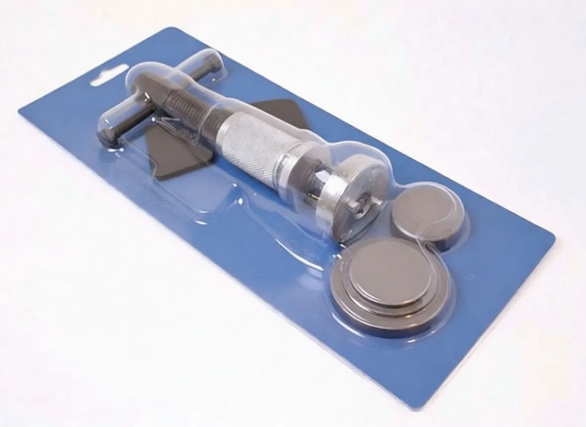 Packaged caliper wind-back kit in blister pack showing tool, multiple adapter plates, and branded blue backing card with barcode.