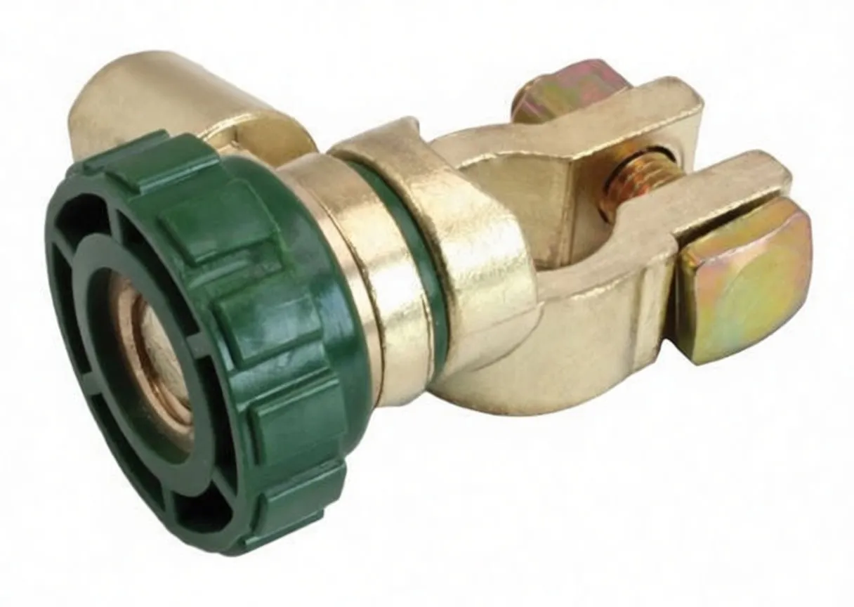 Top-side angled view of brass battery terminal disconnect showing green cap, clamp jaws and conductor opening