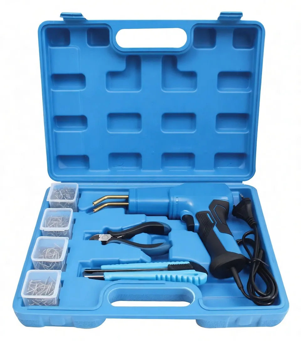 Angled shot of open case with welding gun, bent brass nozzles, four boxes of staples, pliers and a utility knife