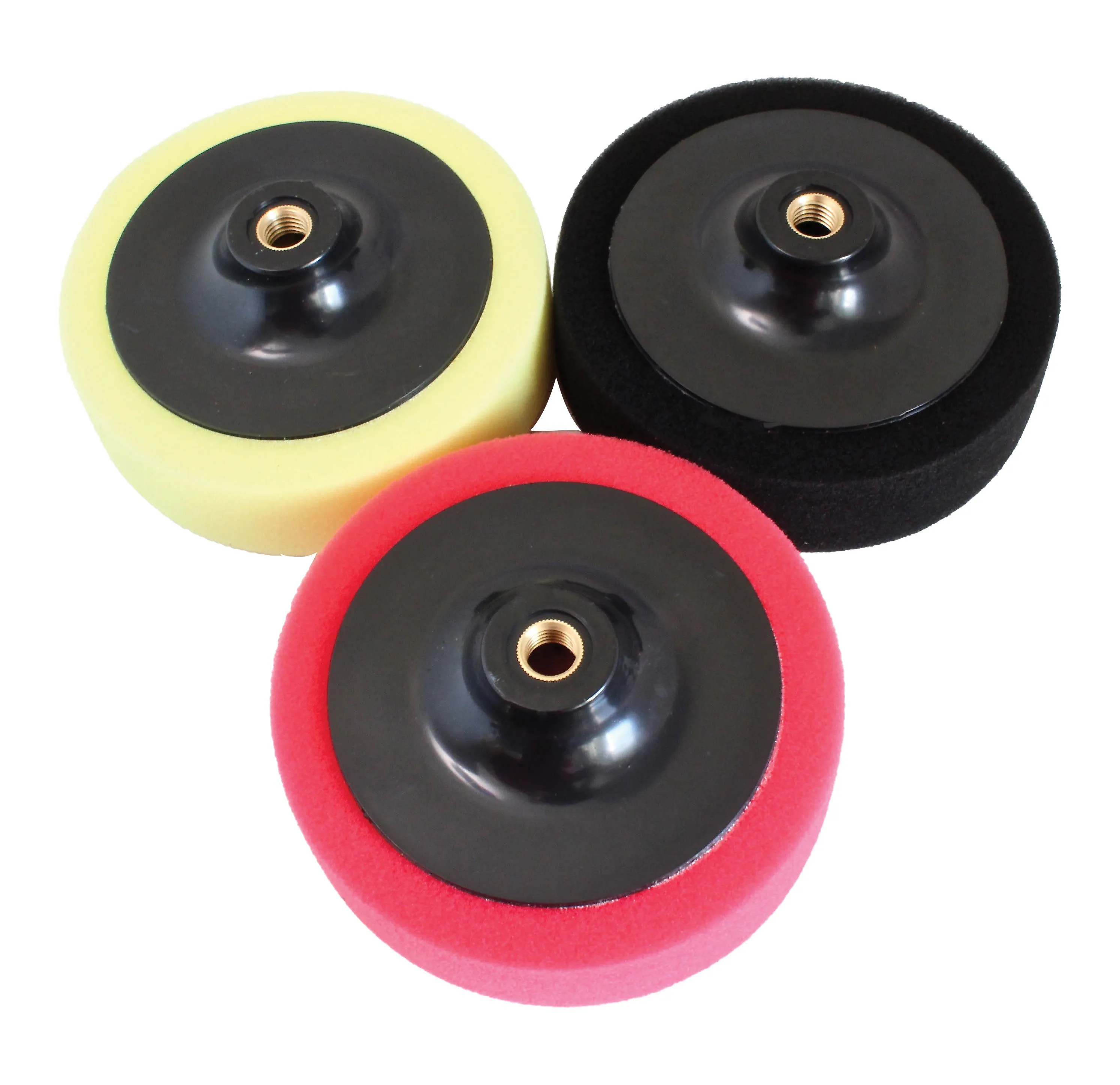 Top-down view of three polishing pads showing black backing plates with brass threaded inserts