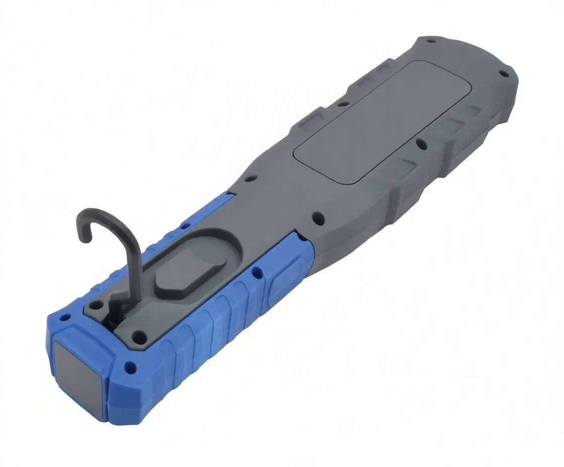 Backside of work light with buttons, USB port cover, magnet pad and fold-out hook