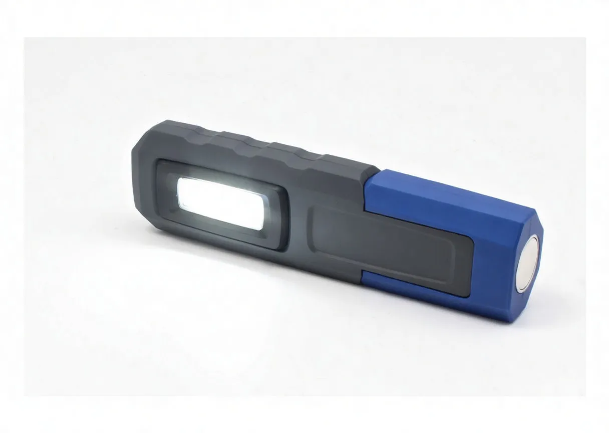 Gloved hand holding ASTA rechargeable work light to show size