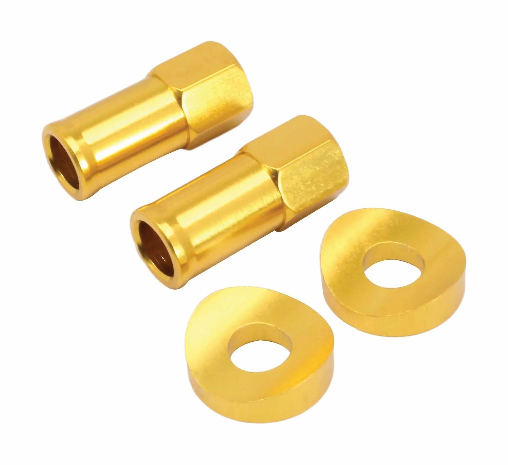 Angled view of two gold extended rim lock nuts with visible hex flats and two thick beveled spacers with central holes.