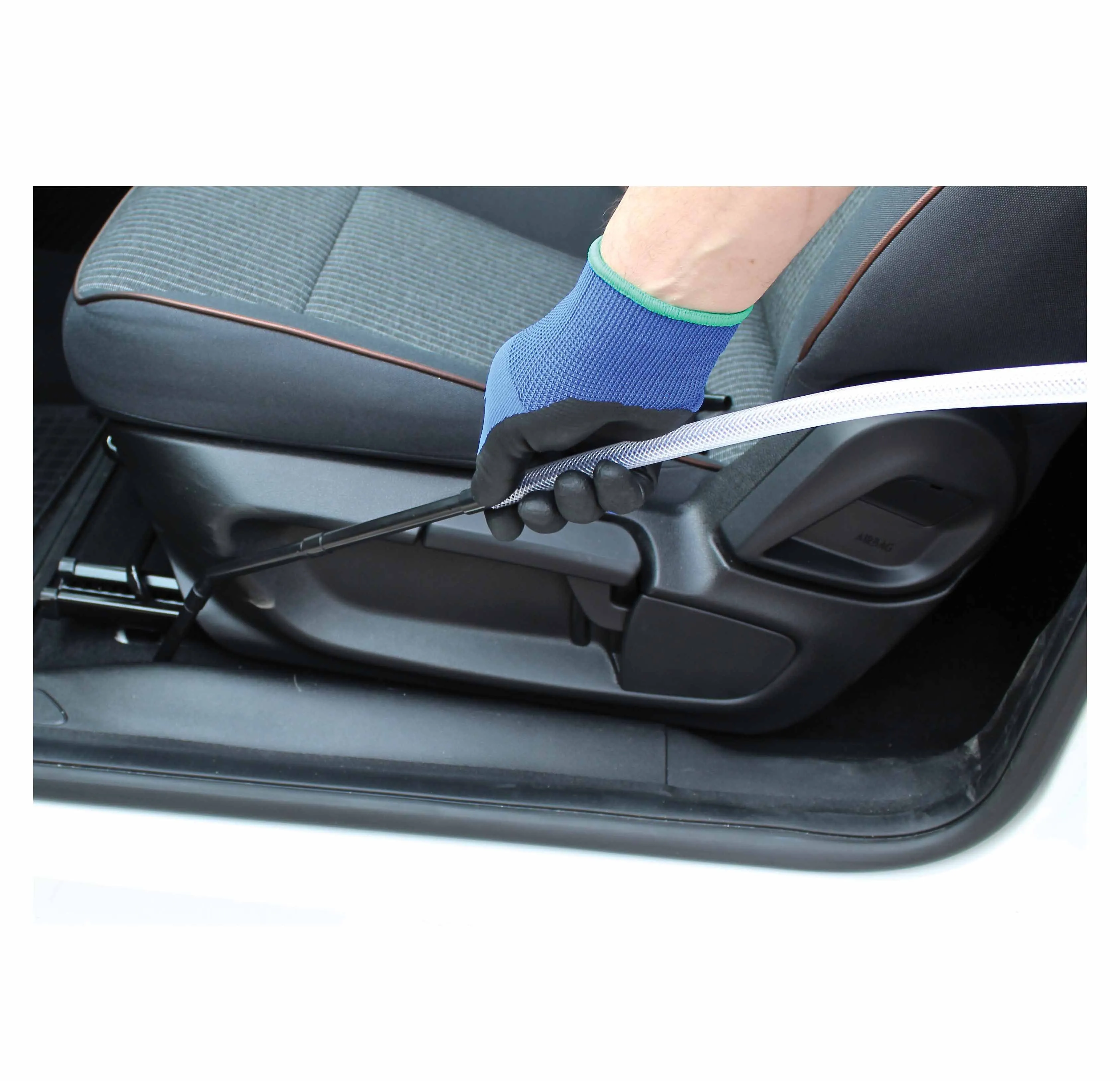 Gloved hand using thin vacuum nozzle and clear hose to reach under car seat