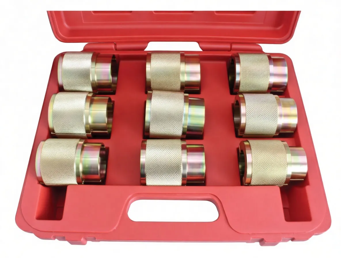 Close top view of nine knurled metal seal driver sleeves arranged in a red plastic case, one with a red foam ring.