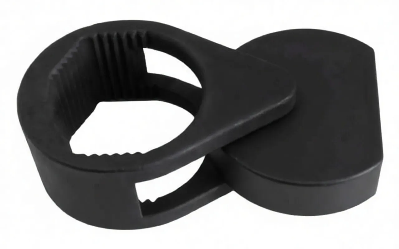 Top/angled view of the black wrench highlighting the toothed circular jaw, two square drive openings, pivot and ASTA marking