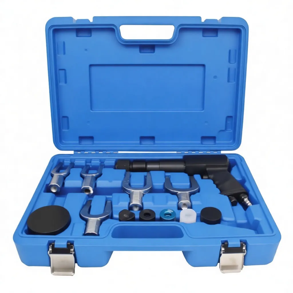 Angled view of open blue tool case with air hammer, chisels in lid, fork pullers and spacer discs in tray