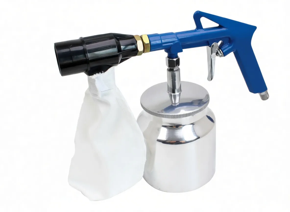 Close-up of blue sandblaster gun on aluminium tank with white fabric bag and small label on lid