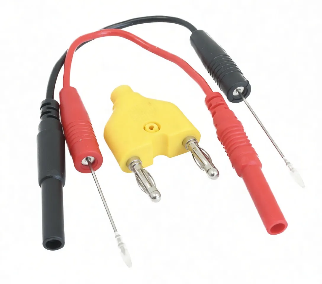Overhead view of red and black probe leads connected to a yellow two‑pin banana plug adapter, probes with clear caps