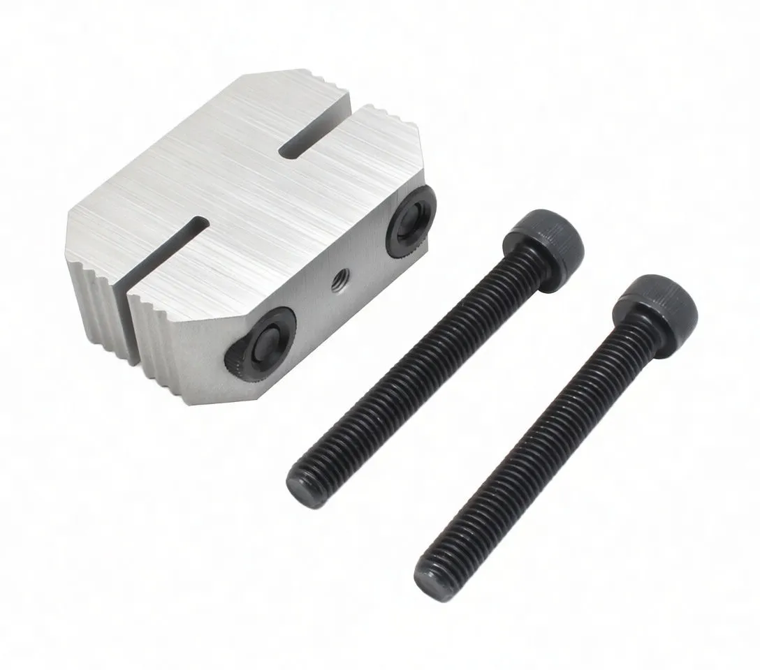 Perspective photo of aluminium clamp jaw with white V-block and two black socket-head bolts beside it