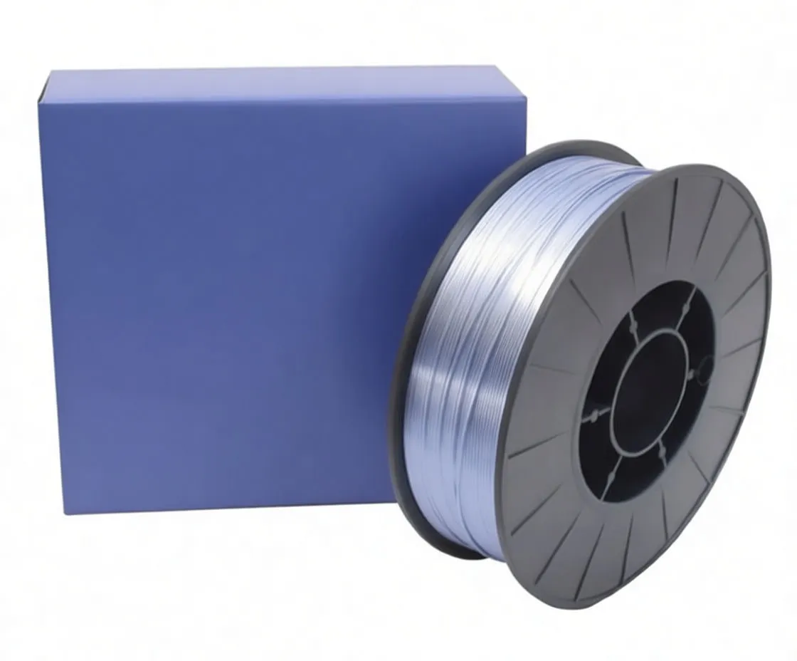 Close angled shot of a black reel of aluminum welding wire sitting on a blue saTra box, showing the spool face, wound wire and product label on the box.