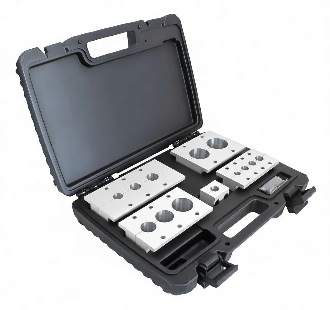 Collection of machined aluminum V-blocks and saddles arranged on white background, some marked with logo and size engravings