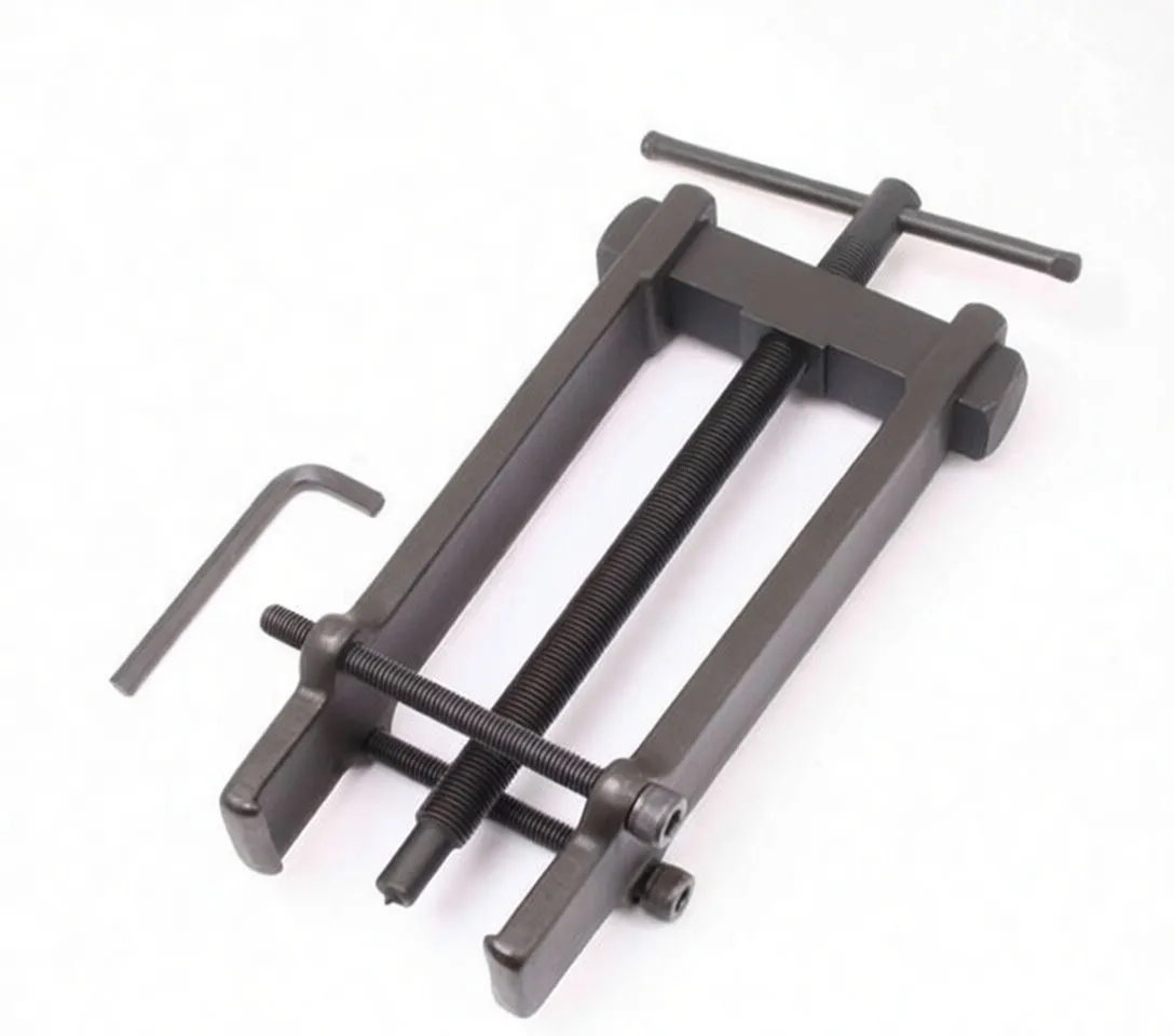 Long view of dark metal armature bearing puller with central threaded rod, removable pin, side nuts and ASTA marking