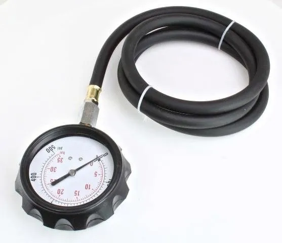 Close-up of pressure gauge with scalloped rubber bezel attached to a coiled black hose, white dial with red and black markings