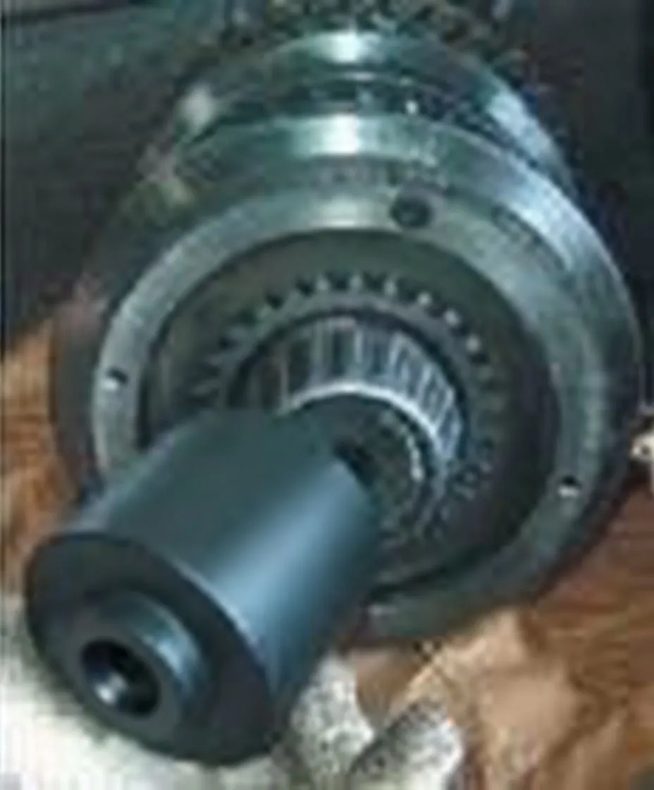 Socket installed on transmission/clutch hub nut on splined shaft with bearings visible