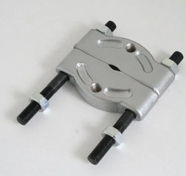 Angled view of forged steel bearing separator, showing split halves, oval opening, threaded rods and hex nuts.