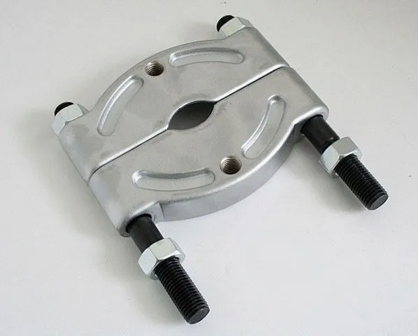 Split circular metal bearing separator on a light background showing threaded rods, hex nuts, and central opening
