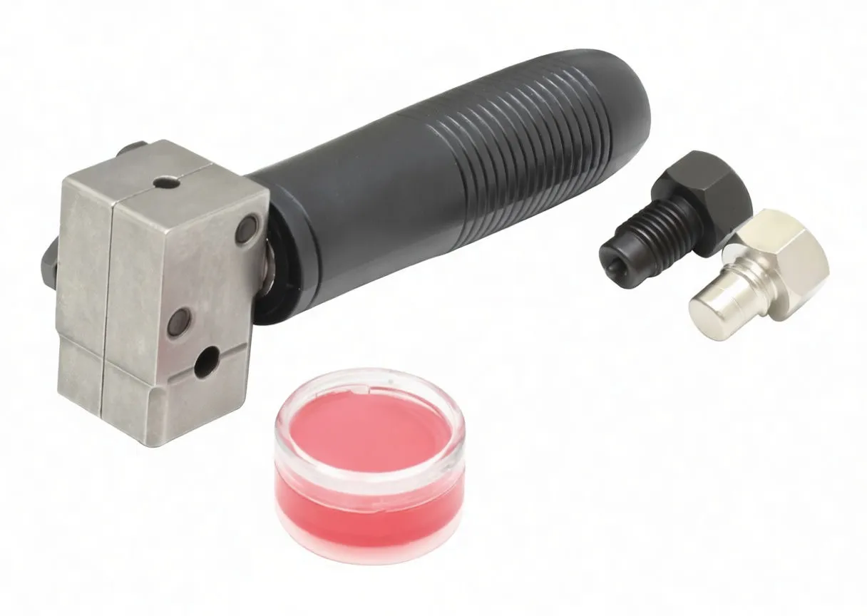 Angle close-up of flaring head, ribbed handle, grease pot and two metal adaptor punches