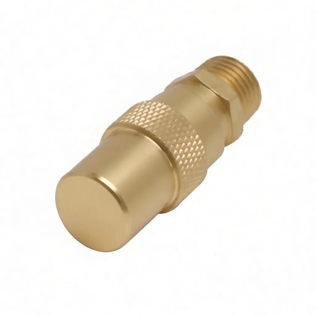 Front view of brass safety valve cap with small central hole and engraved text around the rim, knurled section behind