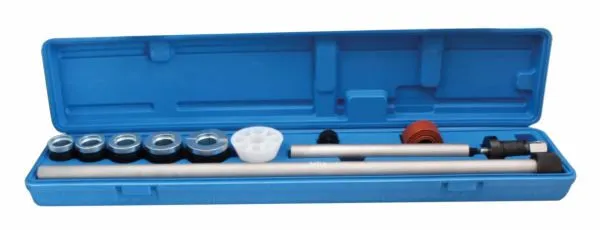 Long blue tool case open showing lined-up bearing drivers, white adapter, two aluminum rods and red cone adapter