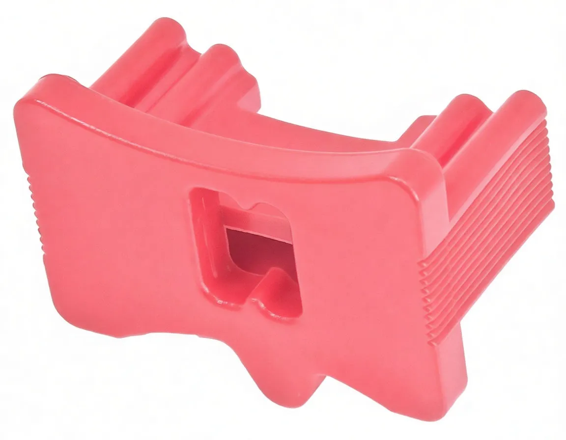 Rear face of red plastic timing tool part with large central opening and serrated sides