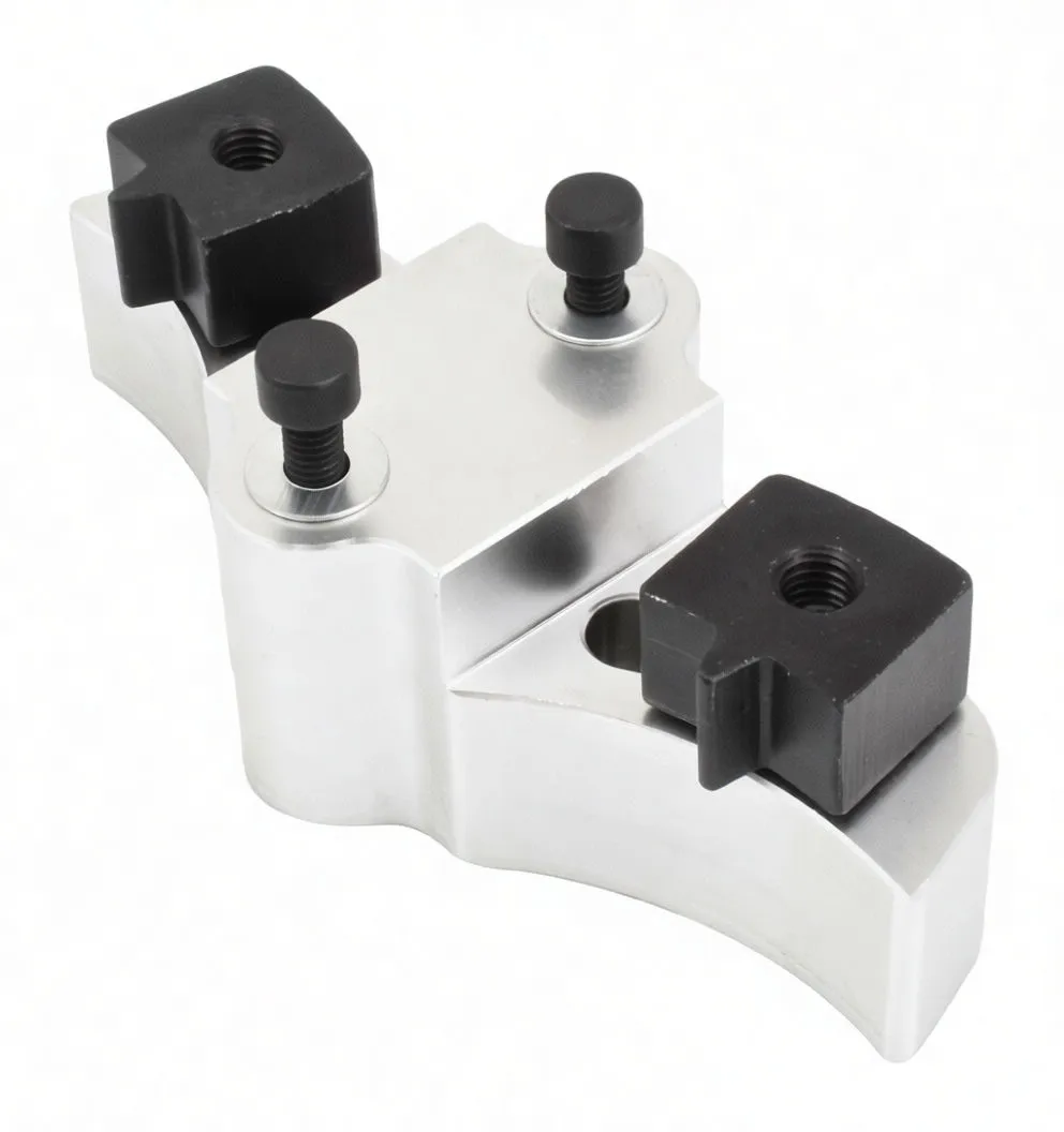 Underside view of the aluminium camshaft locking tool showing two central studs, two recessed bolt slots, contoured curved profile and black inserts