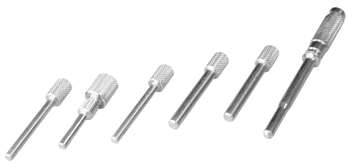 Seven knurled steel alignment pins and driver tools arranged in a row.
