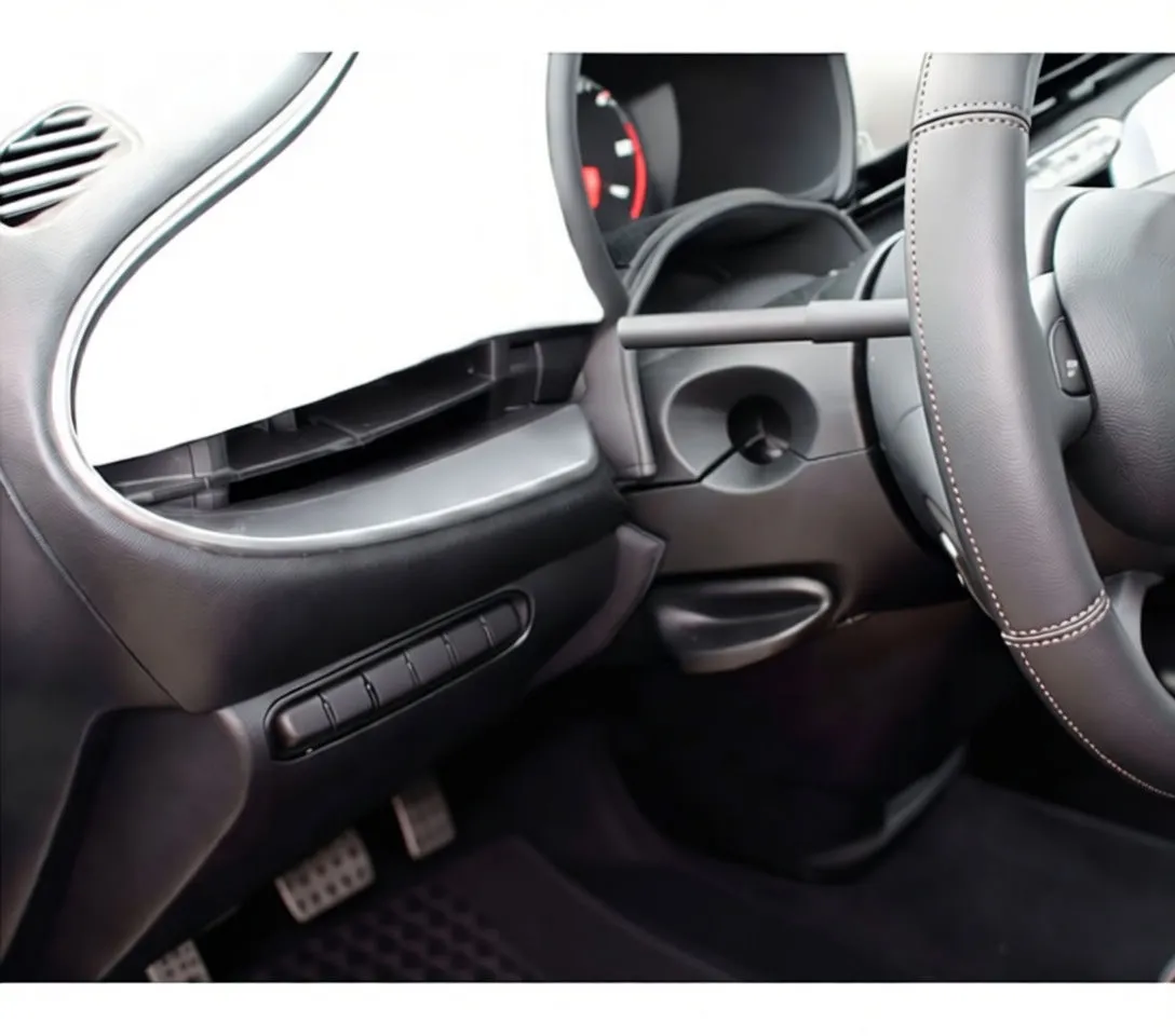 Vacuum wand with angled nozzle inserted into dashboard pocket with red arrow pointing at it