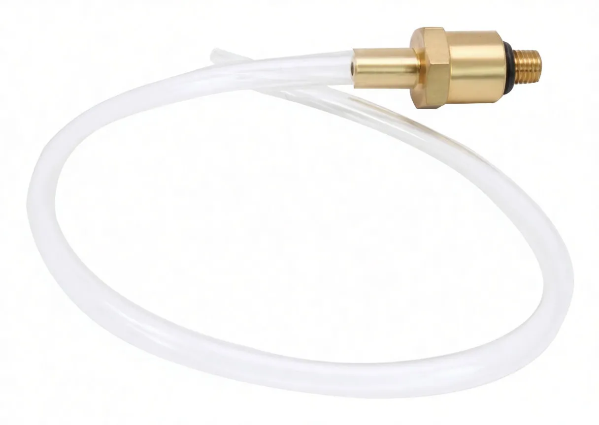 Loop of transparent tubing connected to a brass hex nut fitting and threaded tip with a black O‑ring, showing a faint stamp on the brass.