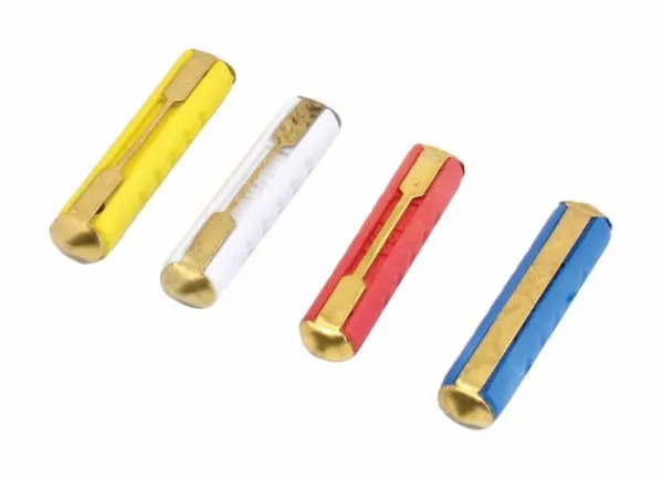 Close-up diagonal view of yellow, white, red and blue 6x25mm fuses showing brass ends and center conductor