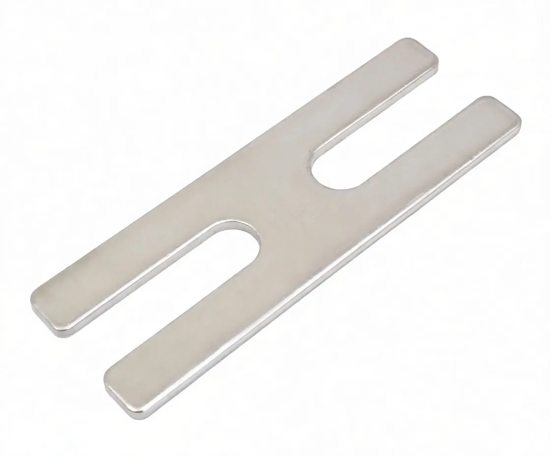 Angled view of fork-shaped cartridge rod holding plate showing markings and thickness