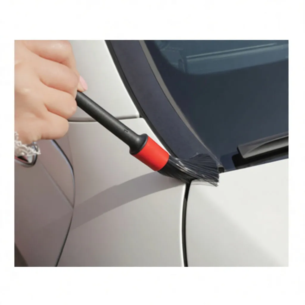 Hand wearing chenille microfiber mitt cleaning a car door handle