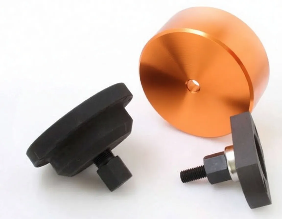 Orange anodized cup and black threaded adaptors showing ASTA marking